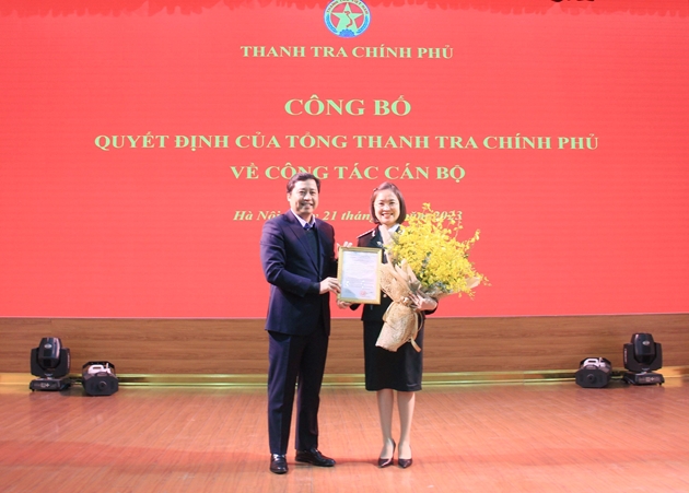 Phó Tổng Thanh tra Dương Quốc Huy trao quyết định và tặng hoa chúc mừng tân Phó Vụ trưởng Vụ Tổ chức cán bộ Nguyễn Thị Thu Huyền. Ảnh: PH